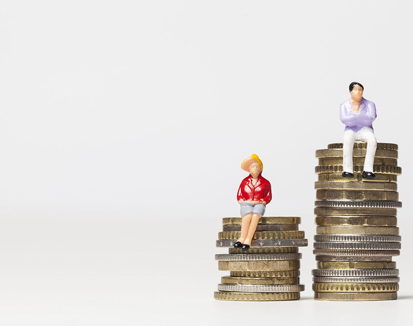 Gender pay equality concept. man and woman on a stack of coins.